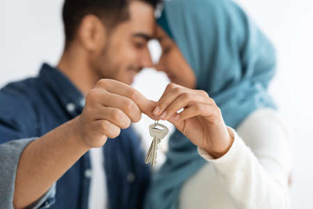 Key chain in loving muslim couple hands, selective focus