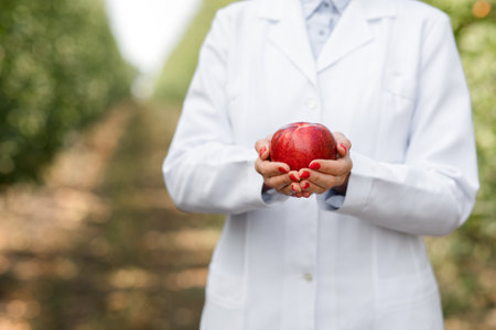Business owner, agronomist shows organic fruits grown on eco farmの写真素材