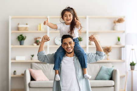Playful middle-eastern father and daughter having fun at homeの写真素材