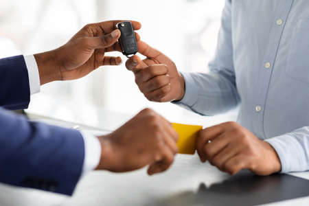 Buying Vehicle. Man Giving Credit Card To Manager And Taking Car Keysの写真素材