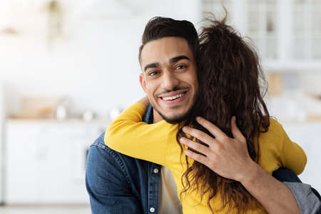 Fathers Love. Portrait Of Happy Young Middle Eastern Dad Embracing Little Daughter