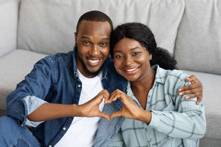 Portrait Of Joyful Romantic African American Couple Making Heart Gesture At Camera