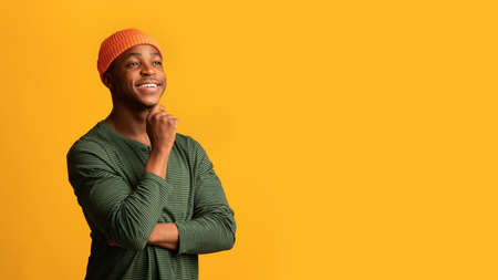 Good Offer. Pensive Young African-American Guy Looking At Copy Space With Interest