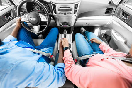 Black couple enjoying drive on car, holding hands