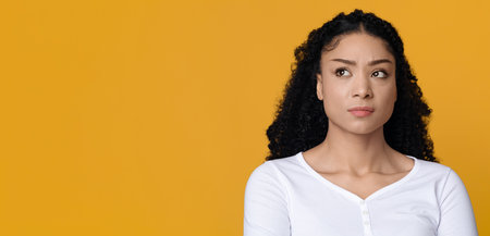 Portrait Of Doubtful Unpleased African American Woman Looking Aside At Copy Spaceの写真素材