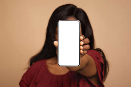 lady covering her face with empty screen cellphone, mockupの写真素材