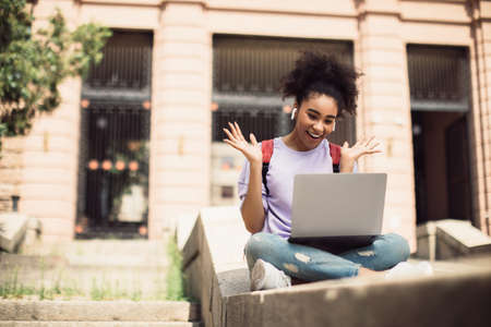 Black Student Girl Video Calling Having Online Lecture Outdoorsの写真素材