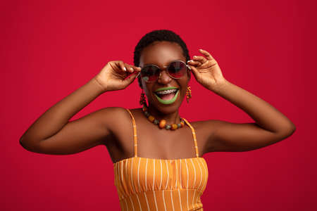 Pretty african american young woman trying new sunglassesの写真素材