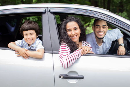 Happy Family Ride. Cheerful Arab Parents And Little Son Sitting In Carの写真素材