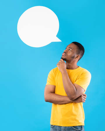 African Man Posing With Speech Bubble Above Head, Blue Backgroundの写真素材