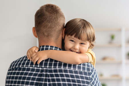 I love my daddy. Close up portrait of happy cute little boy embracing his father and smiling to cameraの写真素材