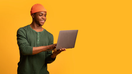 Portrait Of Young African American Man With Laptop Computer In Handsの写真素材