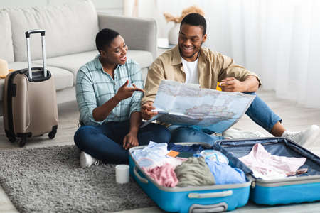 Black Spouses Holding Touristic Map Choosing Country For Vacation Indoor