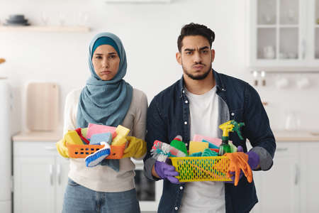 Bored muslim family cleaning their new apartmentの写真素材