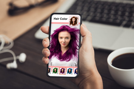 Young lady trying new hairstyle via hair simulation mobile applicationの写真素材