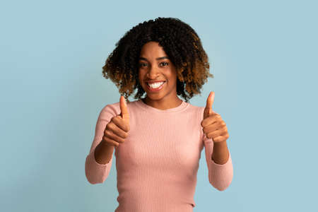All Is Great. Positive Young Black Woman Showing Thumbs Up At Cameraの写真素材