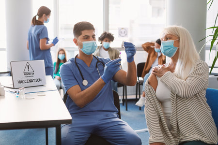 Doctor Taking Dose Of Vaccine For Senior Womanの写真素材