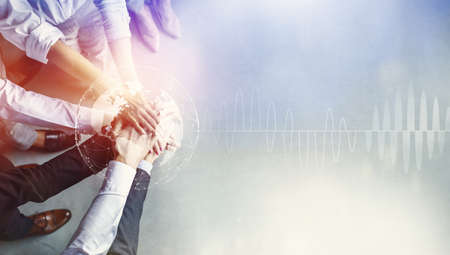 Unrecognizable confident businessman and workers holding hands standing, double exposure with...