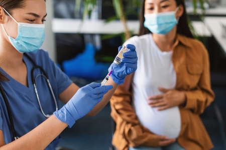 Doctor Taking Dose Of  Vaccine For Pregnant Woman