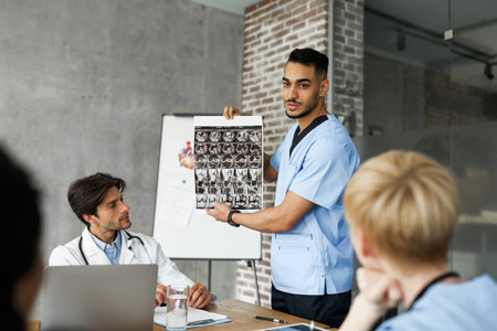 Middle-eastern doctor showing his colleagues MRI scanの写真素材