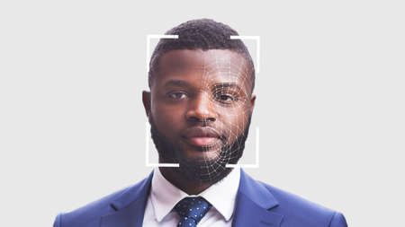 Portrait of young black businessman on white, having face recognition