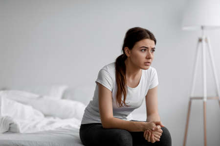 Shocked sad european young woman suffering from mental problems, stress and loneliness, feeling...