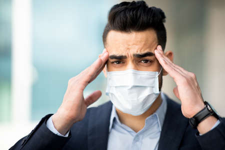 Sick arabic manager working while coronavirus pandemicの写真素材