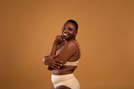 Portrait Of Curvy Smiling African American Woman In Underwearの写真素材