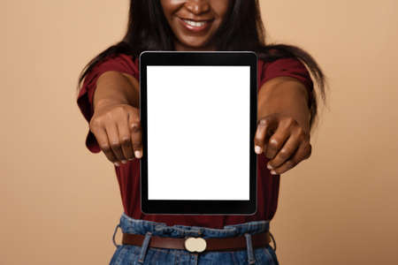 Cropped of african american woman showing digital tablet, mockupの写真素材