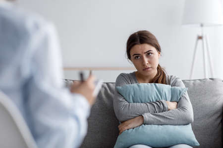 Unhappy sad caucasian millennial lady suffering from depression, anxiety and mental problemsの写真素材