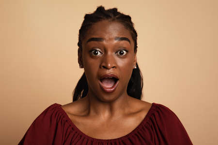 Closeup portrait of shocked african american womanの写真素材