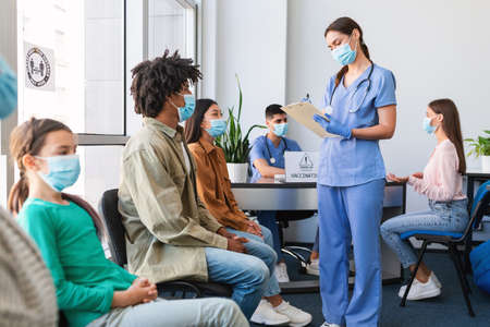 Diverse Patients Waiting For Covid-19 Vaccination Sitting In Queueの写真素材