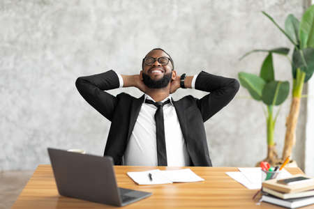 African American man leaning back taking breakの写真素材
