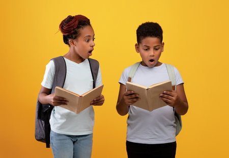 Excited african american boy and girl going to schoolの写真素材