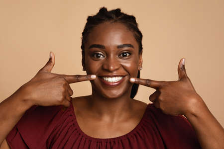 Positive black woman showing her beautiful white teethの写真素材