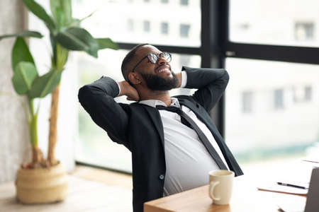 African American business man leaning back taking breakの写真素材