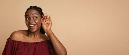 Curious african american young woman listening to something
