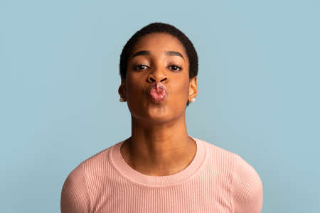 Young Beautiful Black Female Blowing Air Kiss At Cameraの写真素材
