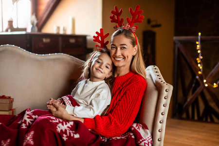 Portrait of happy woman and daughter celebrating xmasの写真素材