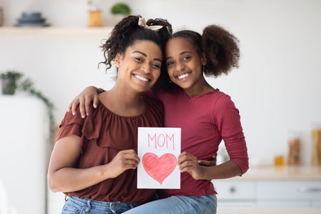 Cute black girl greeting her mom with Mothers Dayの写真素材
