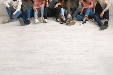 Legs of multiracial group of people chilling together, copy spaceの写真素材