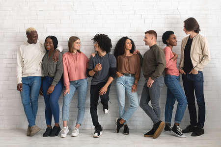 Carefree multiracial group of friends chilling together indoorsの写真素材