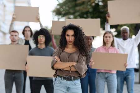 Active woman leading a group of demonstrators on the streetの写真素材