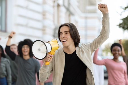 Charismatic guy activist with megaphone on the street