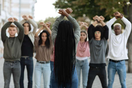 Unrecognizable long-haired black woman leading group of protestorsの写真素材