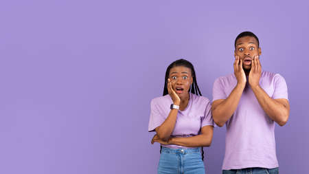 Scared shocked African American couple looking at cameraの写真素材