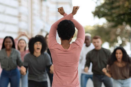 Rear view of african american female activist leading angry protestorsの写真素材