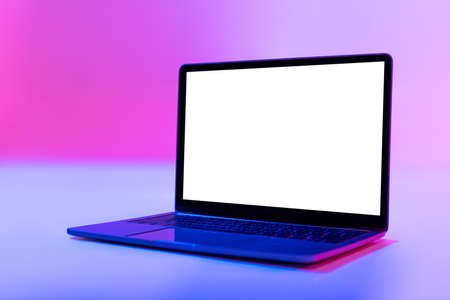 Modern laptop pc with empty white screen in neon light, space for website or desktop. Mockupの写真素材