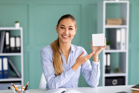 Female blogger recording review video of product in box with copy space, mockup for your designの写真素材