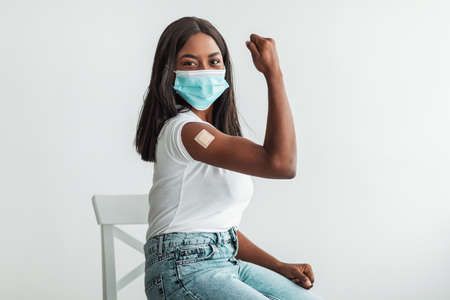 Black Vaccinated Female Showing Shoulder With Patch And Bicepsの写真素材